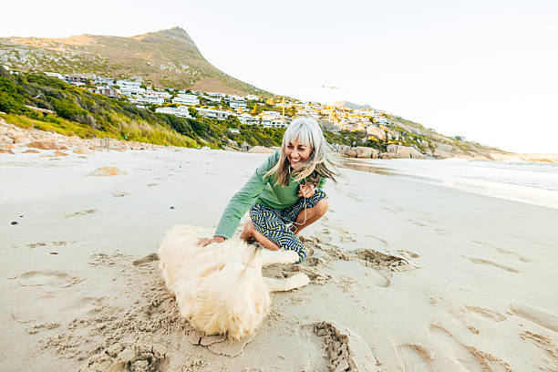 Senior woman enjoying her time outdoors with her dog