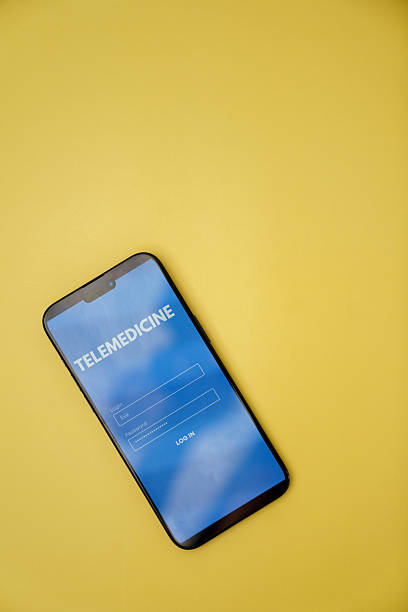istock Smartphone Displaying Telemedicine Application on Yellow Background 2218840814