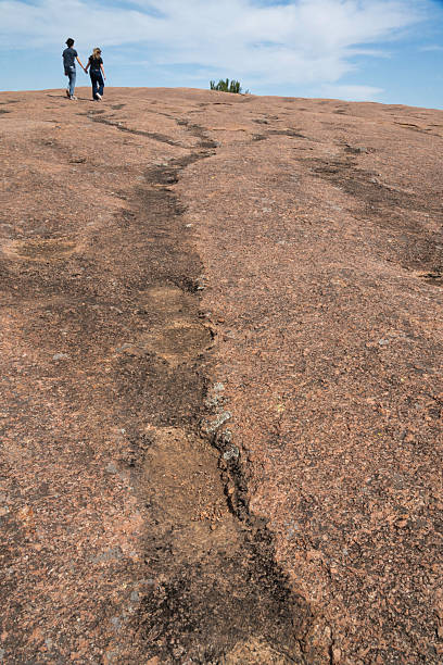 istock Couple in their 20's hike up Enchanted Rock, Austin, Texas 2218841561