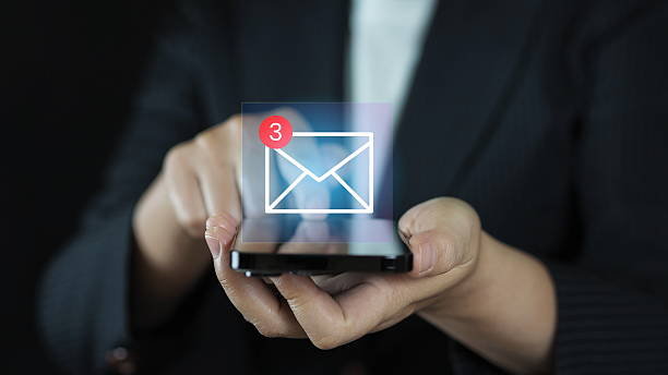 istock Digital marketer using email marketing tools on smartphone, sending newsletters and analyzing campaign performance to engage subscribers and grow business through personalized content 2218852548