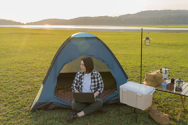 istock Freelance woman working on laptop while camping outdoors 2218854232