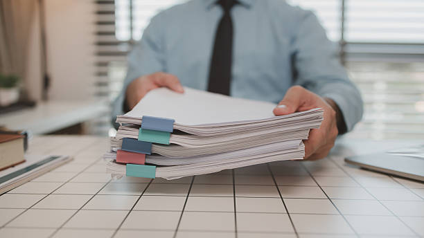 istock a businessman is handling documents in the office, an accountant is collecting documents, a marketing manager is preparing information for a meeting, finance, startup, company 2218856184