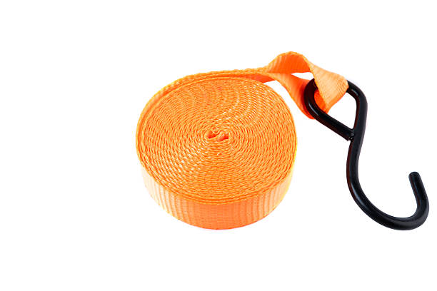istock Bright orange cargo strap with a metal hook and ratchet, isolated on white background. New equipment used for securing loads or for transport. 2218856504