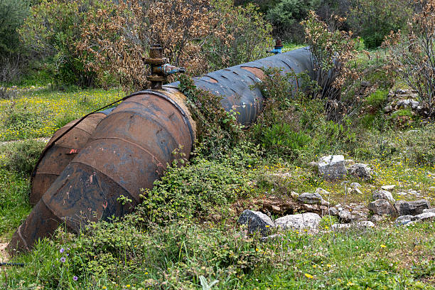 istock Old big rusty water pipe in a rural area. 2218858527