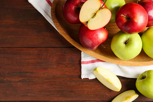 istock Fresh red and green apples on wooden table, flat lay. Space for text 2218858832