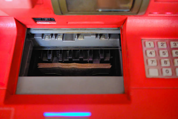 A visual representation of banknotes within an ATM, symbolizing the growing burden of monthly expenses on employees, even as their salaries rise