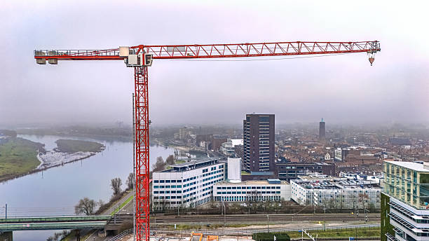 Construction site with crane aerial drone view from above, building construction and Venlo town cityscape, the Netherlands