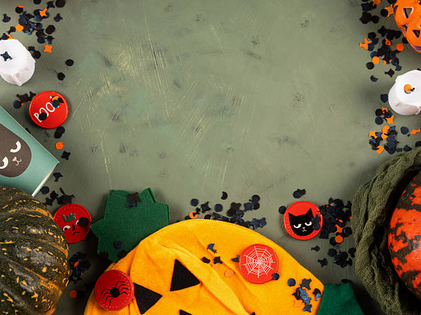 istock Halloween green frame background flatlay with pumpkins and party decor 2218865415