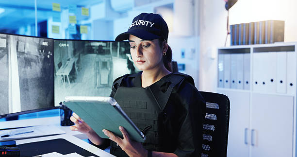istock Security guard, woman and tablet with surveillance video, observation app and watching at night. Officer, cctv station and technology in control room for monitor, safety or footage for protection 2218866221