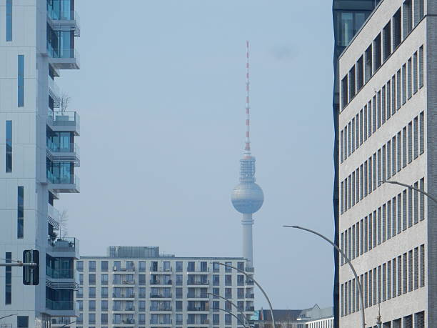 The road near the East Side Gallery in Berlin-Friedrichshain, with Alexanderplatz tower in the background, Germany