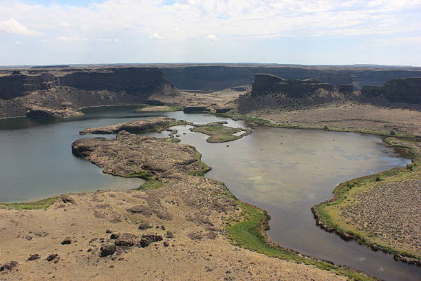istock Scenic view of river winding through rugged terrain and cliffs in a desert landscape during daytime 2218869105