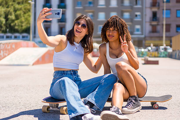 istock Two young women taking a selfie while sitting on skateboards 2218869272