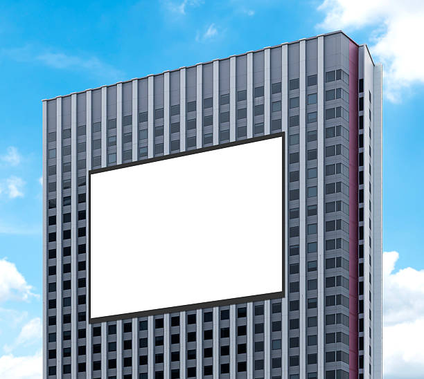 istock Mock up white horizontal large LED display billboard on tower building with blue sky background .clipping path for mockup 2218870070