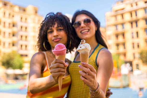 istock Two young women showing ice cream cones in summer 2218870186