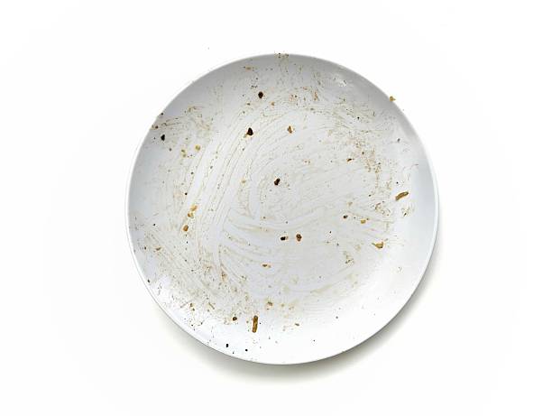 Dirty white plate with leftovers food isolated on white background, Top view