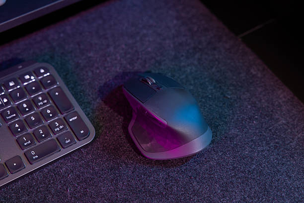 istock Ergonomic Computer Mouse and Keyboard Detail in Vibrant Neon Workspace 2218872136