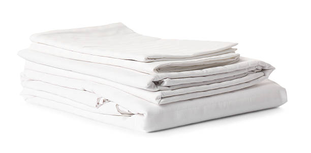 istock Stacked clean bed linens on white background 2218874024