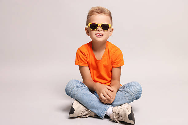 Little boy with sunglasses on light grey background