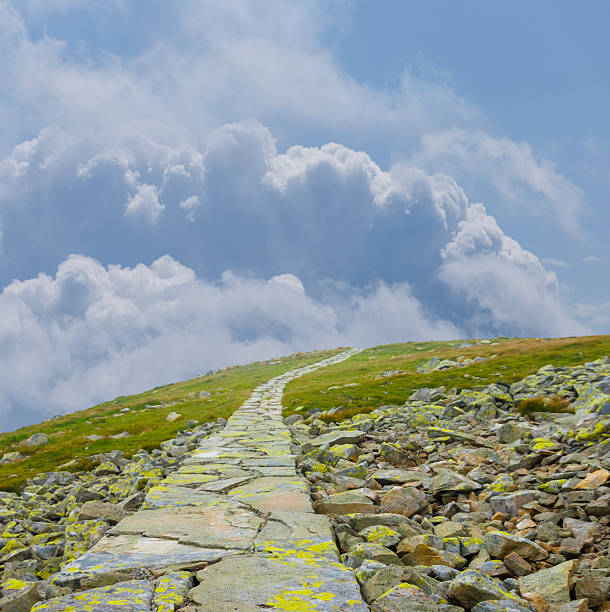 green mount slope under blue cloudy sky