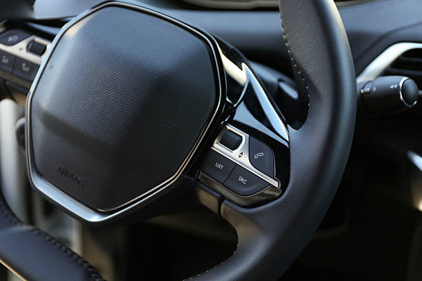 istock Steering wheel and dashboard inside of modern luxury car, closeup 2218874552