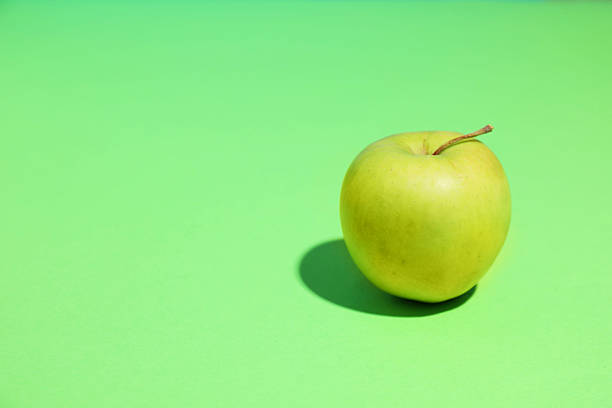 istock Fresh ripe apple on light green background, space for text 2218874583