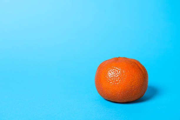 istock Fresh ripe tangerine on light blue background. Space for text 2218874592