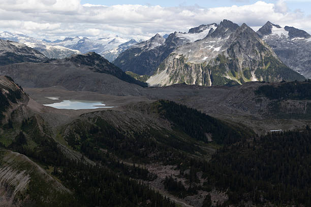 istock Breathtaking mountain range with expansive valleys and serene lake on a cloudy day in Canada 2218874791