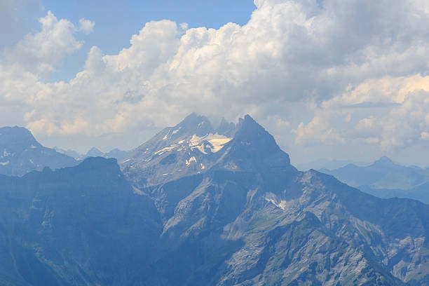 Mountain panorama with mountain range Dents du Midi in the clouds seen from summit Dent de Morcles in Swiss Alps, Switzerland