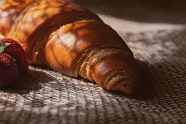 istock Fresh Croissant with Strawberries and Mint on Rustic Burlap Background 2218880145