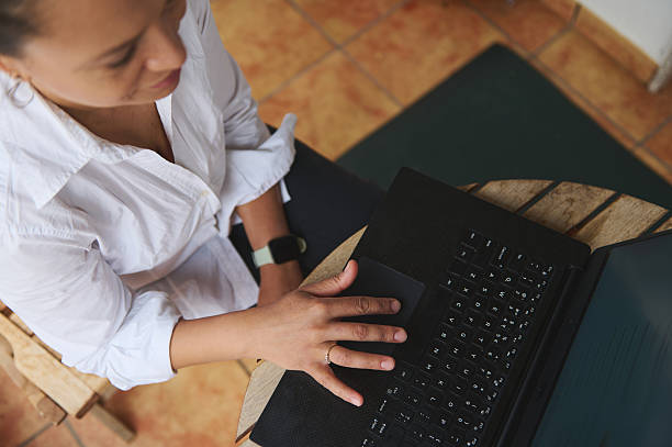 istock Professional Woman Working On Laptop In Casual Workspace 2218880670