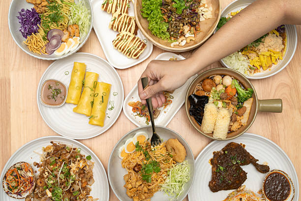 istock Colourful Asian Food Spread with Hand Picking from Bowl 2218881163