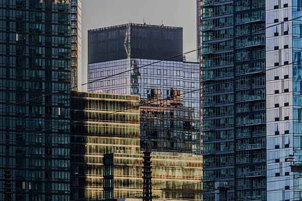 Reflection of a historic architectural building in the glass facade of a modern high-rise. The image captures the juxtaposition of traditional and contemporary urban design in a cityscape setting.