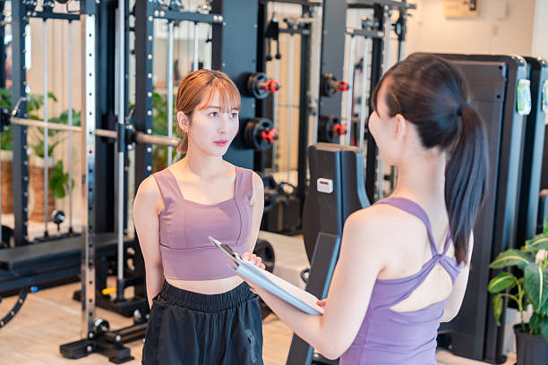 istock Woman doing muscle training with guidance from a female trainer. 2218881472