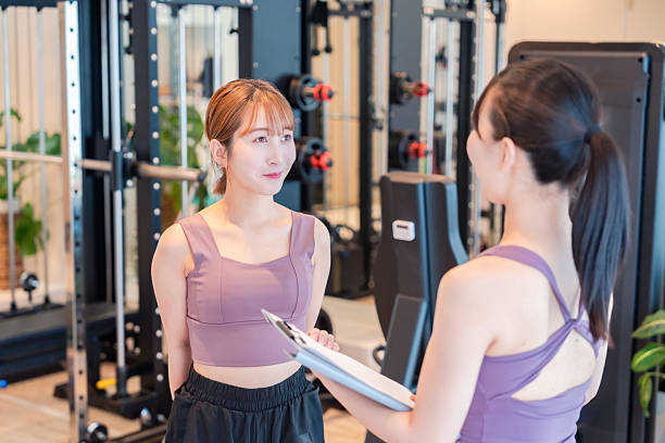 istock Woman doing muscle training with guidance from a female trainer. 2218881473
