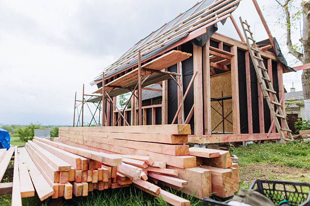 istock Stacked lumber at the frame house construction site 2218885923