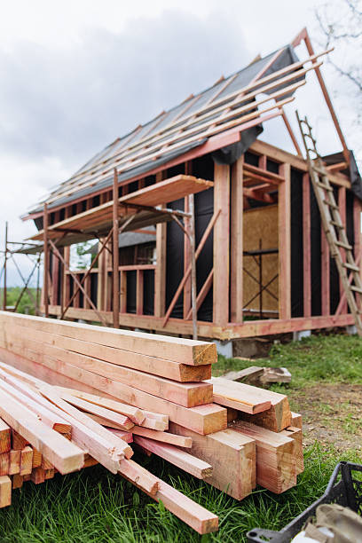 istock Stacked lumber at the frame house construction site 2218885936