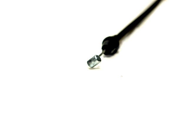 istock a black cable with a metallic end and a red tip on the opposite end, set against a plain white background. It type of control cable for a vehicle 2218886196