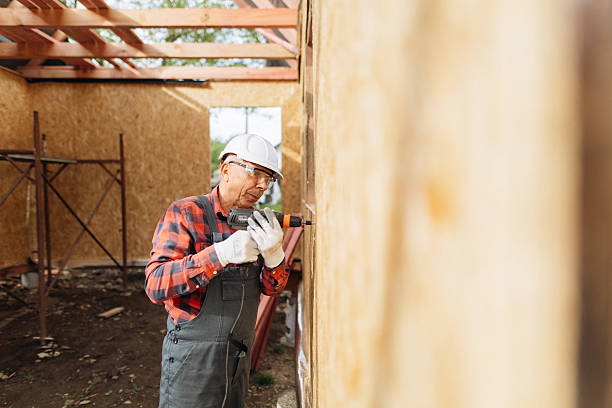 istock Skilled Carpenter Securing OSB Sheathing with Power Drill at Wood Frame Construction Site 2218887633