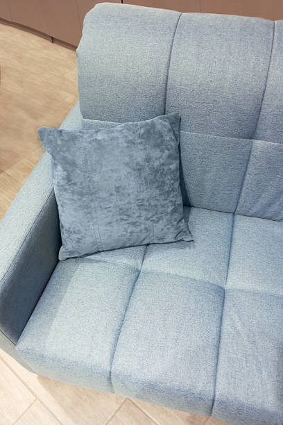 istock Light blue sofa with armrest and decorative pillow in the room. 2218888990
