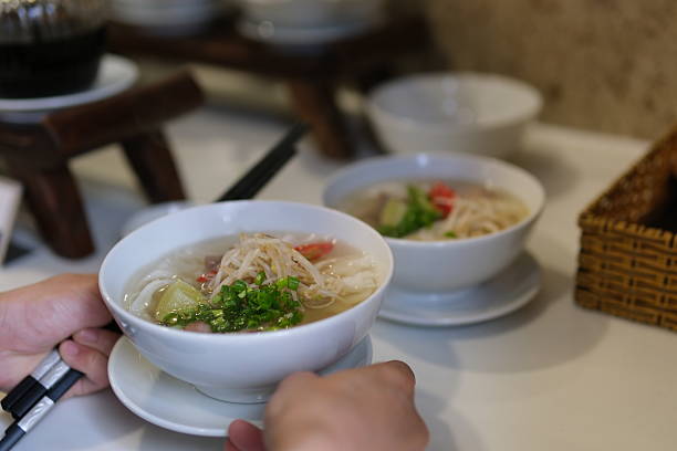istock pho soup Vietnamese Vermicelli Soup Making Process Vietnam pho bo seller preparing rice vermicelli soup on the street small eatery cooking fa soup in Vietnam street food dirt unsanitary 2218890280