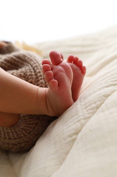 istock Newborn baby's feet on a soft blanket. 2218891544