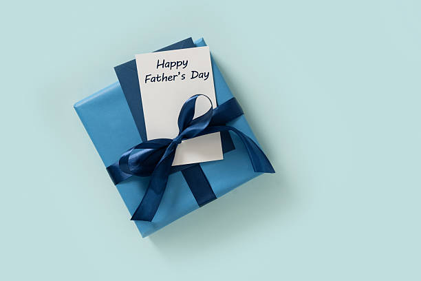 istock Happy Fathers Day gift box and label on blue background. View from above. 2218891775