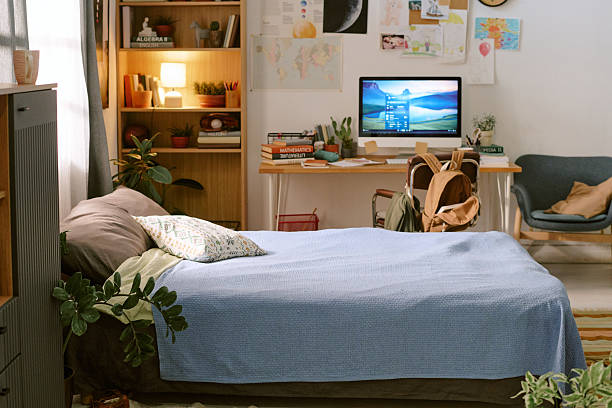 istock Cozy Teenage Bedroom Interior Featuring Study Desk and Computer Setup 2218892497