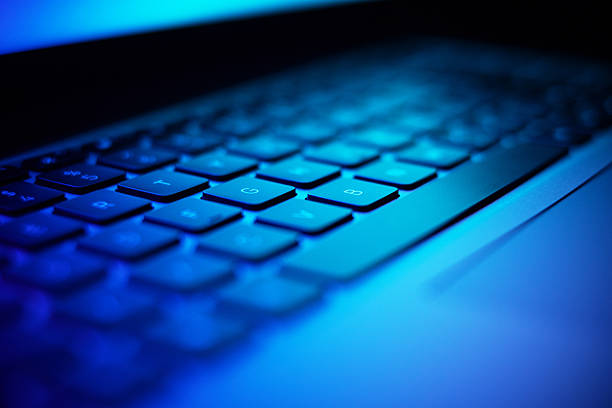 istock Close up image of laptop keyboard in dark neon light. 2218896122