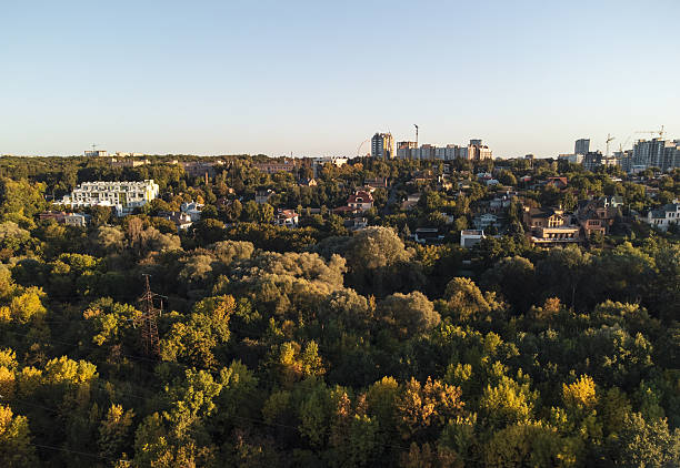 istock Sunny Green Park with Cityscape from Drone 2218898653