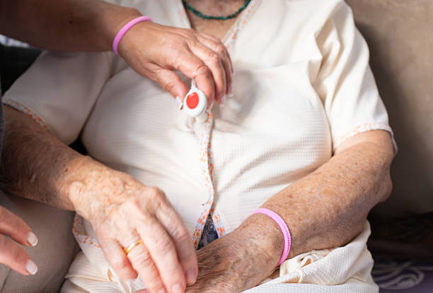 istock Nurse attaching personal emergency response system to senior woman 2218898789
