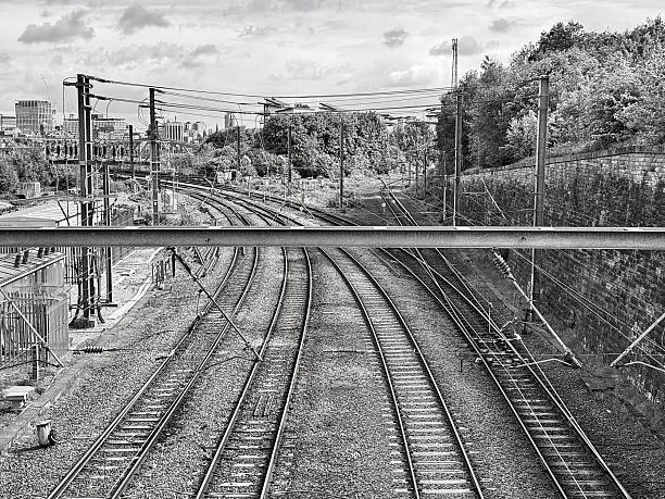 Four empty railway tracks against trees and cloudscape at Newcastle Upon Tyne
