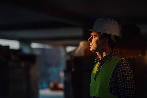istock Construction worker wearing safety vest and helmet inspecting building site 2218900246