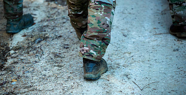 istock Soldier walking on a dirt road during a military exercise 2218900580
