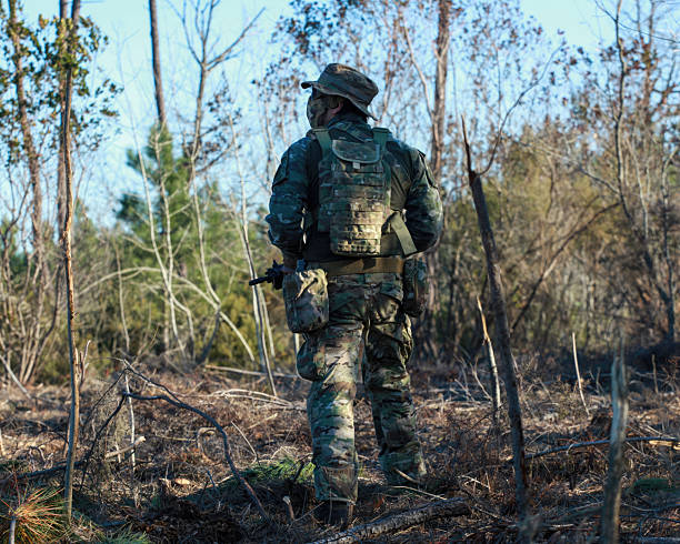 istock Airsoft player wearing camouflage patrolling in the forest 2218900597